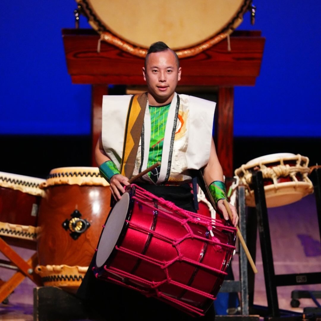 Junya Tsukamoto — on stage playing chu-daiko, taiko drums behind him